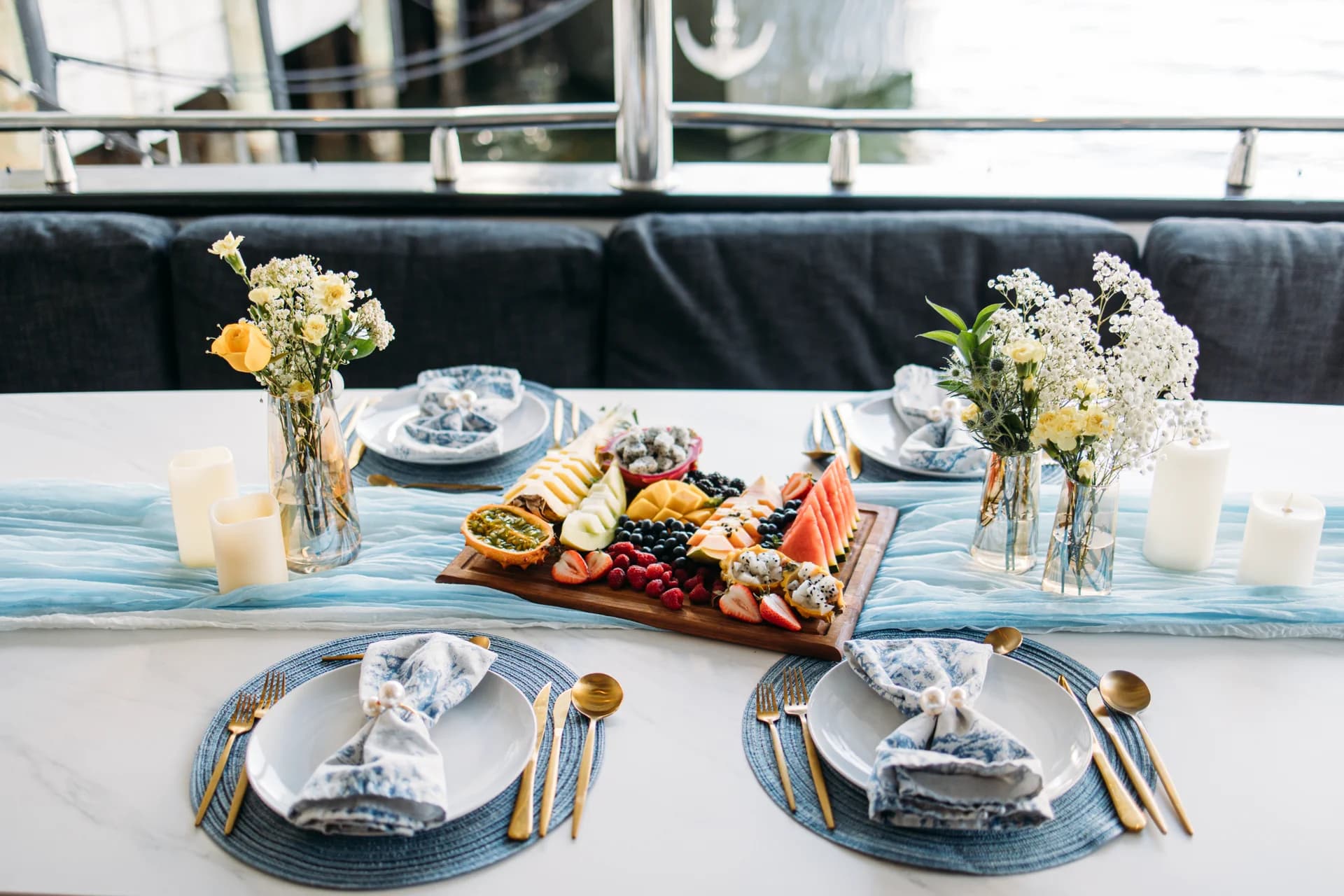 An elegant private dining table set with florals, a grazing board, and fine settings